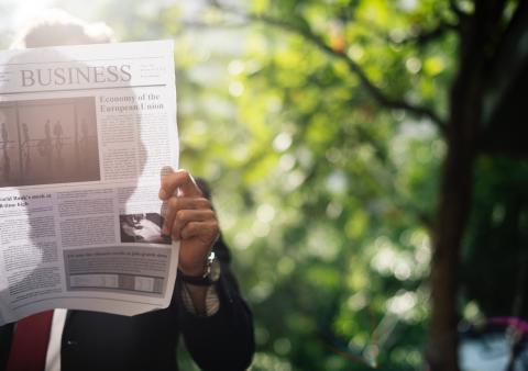person reading a newspaper